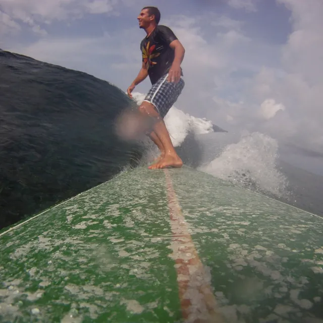 Surfing a wave, photographed from the nose of the board